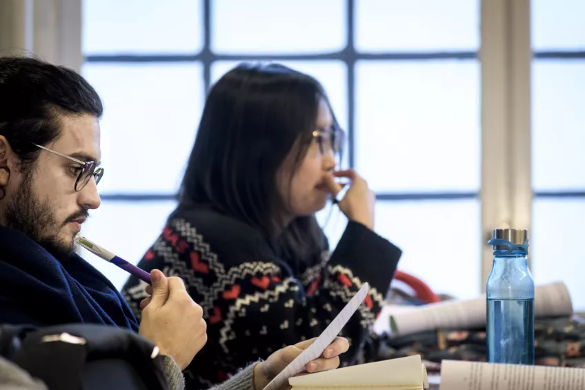 Two students listening at a seminar. Photo.